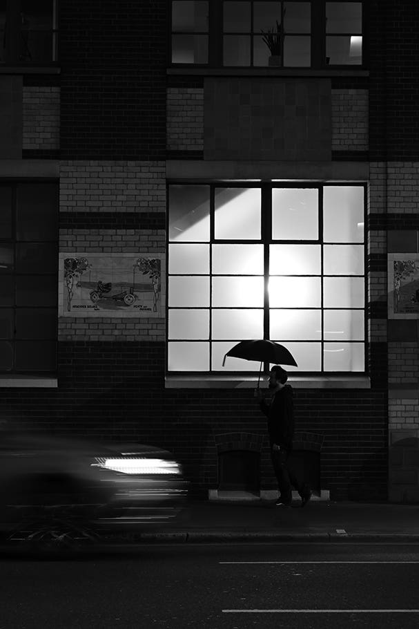 Man with umbrella on the street | Nikon Cameras, Lenses & Accessories